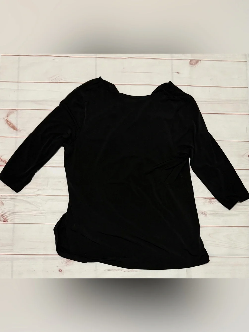 Black Michael Kors blouse with a V-neck, faux-wrap design, and gold bar at the w